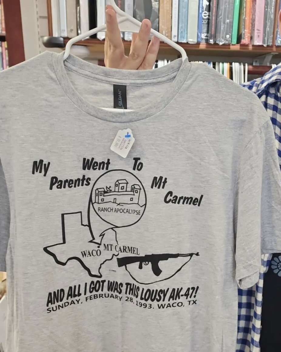 image of grey T-shirt, has the words "my parents went to mt Carmel and all I got was this lousy ak-47, Sunday February 28, 1993, Waco, TX" and "mt Carmel, ranch Approximate". the picture is the outline of Texas, with zoomed in bubble showing the building from the Waco seige from 1993.